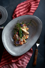 Olivier with crab meat in a beautiful bowl in the form of oysters, on a dark background. Food photo in no way, the concept of food fashion. Healthy nutrition.