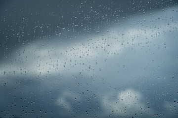 Raindrops on a window during bad, rainy weather.