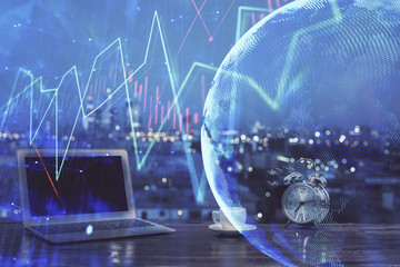 Financial chart drawing and table with computer on background. Double exposure. Concept of international markets.