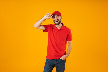 Portrait of happy delivery man in red t-shirt and cap smiling and posing at camera