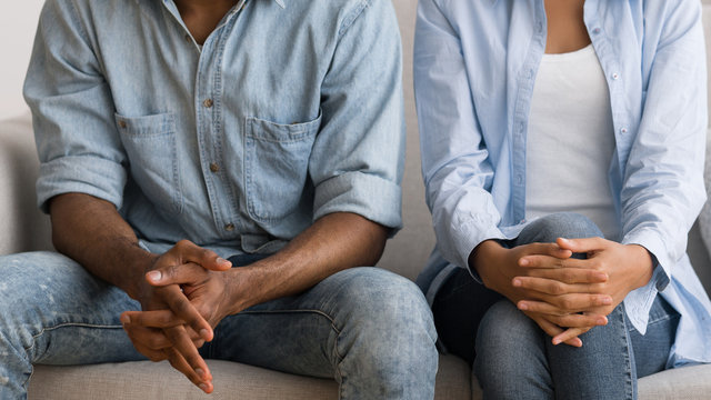 Unrecognizable Afro Couple Sitting On Couch At Marital Counselor's Office