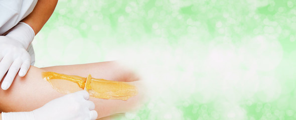 Cosmetologist beautician waxing female legs in the spa center beauty salon depilation epilation isolated