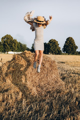 Little girl Outdoors enjoying nature. Jumping from a haystack