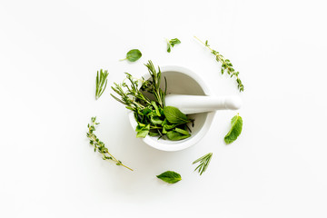 Alternative medicine with medicinal herbs on white background top view