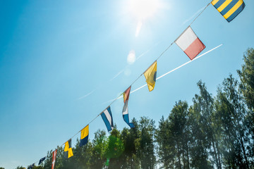 Nautical flags on the ship against blue sky
