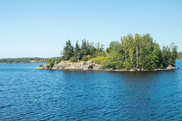 Fototapeta na wymiar Small rocky island in lake Saimaa, near lappeenranta, Finland.