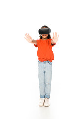 full length view of african american child standing with outstretched hands while using virtual reality headset on white background