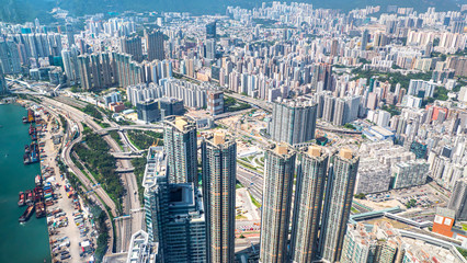 High view of Hong Kong skyline cityscape with car traffic on the road and container ship at industral port