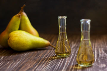 Rakia, rakia, fruit brandy drink and pears on wooden background
