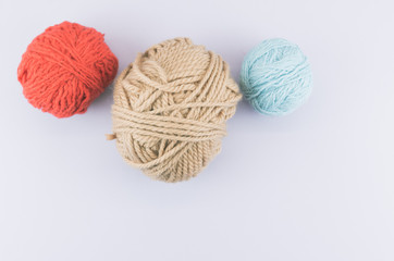 natural wool clew on a light blue surface - objects and materials still life