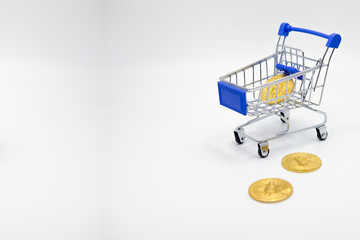 Gold Bitcoin coins, small carts Trading concept, business concept, financial investment concept.