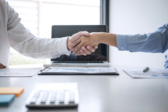 Finishing up a meeting, Business handshake after discussing good deal of Trading to sign agreement and become a business partner, contract for both companies, Successful businessman handshake