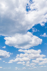 White fluffy clouds in the blue sky in summer