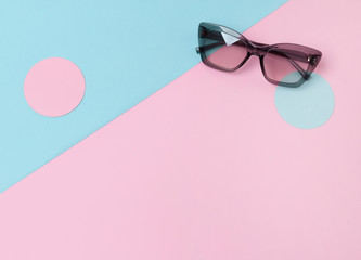 Fashion sunglasses on creative trendy pink and blue background