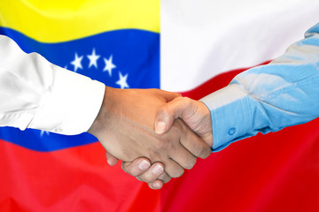 Business handshake on the background of two flags. Men handshake on the background of the Venezuela and Poland flag. Support concept