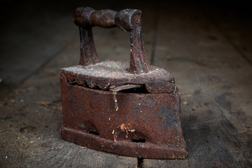 Old rusty iron on wooden floor