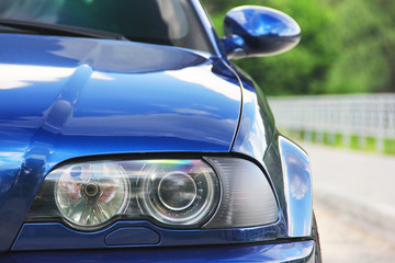 Plakat Car headlights. Luxury Headlights. Part of a blue car
