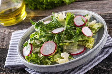 Vegetable salad with  radish, arugula and lettuce on a plate