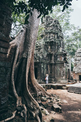 Woman discovering the ruins of Angkor Wat temple complex in Siem Reap, Cambodia