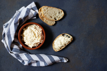 Kajmak or Kaymak. Traditional homemade white cheese. Sandwich with kajmak. Balkan cuisine. Serbian cuisine. Dark background. Top view. Space for text