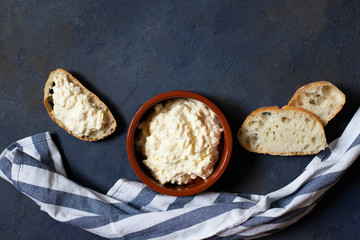Kajmak or Kaymak. Traditional homemade white cheese. Sandwich with kajmak. Balkan cuisine. Serbian cuisine. Dark background. Top view. Space for text