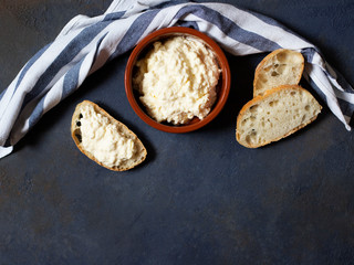 Kajmak or Kaymak. Traditional homemade white cheese. Sandwich with kajmak. Balkan cuisine. Serbian cuisine. Dark background. Top view. Space for text