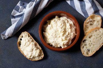 Kajmak or Kaymak. Traditional homemade white cheese. Sandwich with kajmak. Balkan cuisine. Serbian cuisine. Dark background. Top view. Space for text