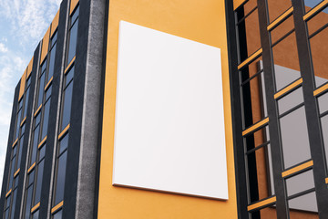 Empty white poster on orange building