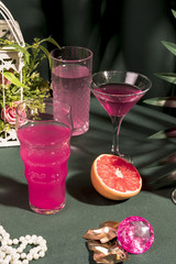 Pink drinks next to girly items on table