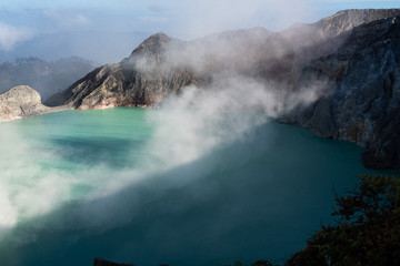 Aerial view of beautiful Ijen volcano with acid lake and sulfur gas going from crater, Indonesia