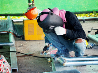 Welding work ,worker with protective welding metal on construction