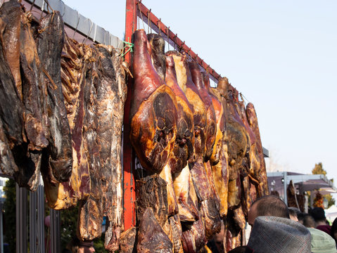 Traditional Serbian and Montenegrian pork called prsut. Homemade prosciutto. Market, street food, food festival. Balkan cuisine. Serbian cuisine