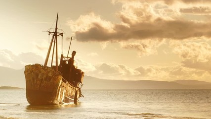 An old abandoned shipwreck, wrecked boat sunken ship stand on beach coast.  Accident at sea. Time lapse 4K