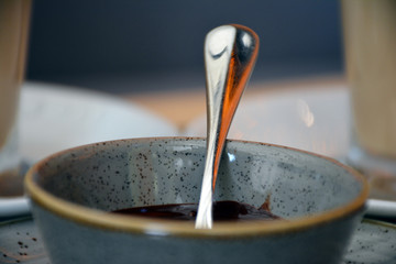 Chocolate dessert. A bowl with a metal spoon and chocolate custard.  