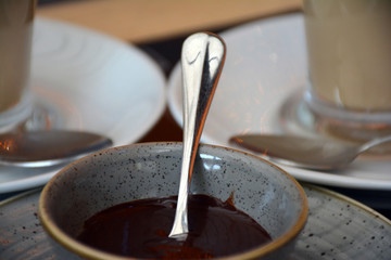 Chocolate dessert. A bowl with a metal spoon and chocolate custard.  