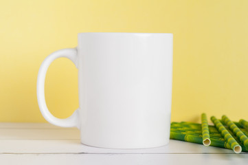 white mug mockup on a yellow background