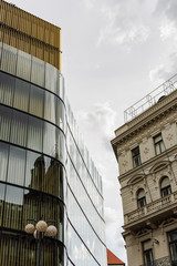 Obraz premium Neighborhood of modern and old buildings in the historical center of Prague, rainy sunny autumn