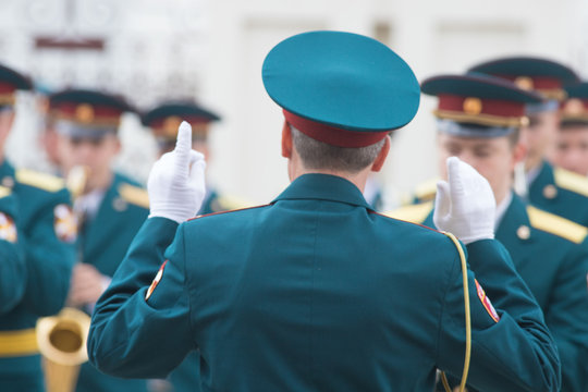 A Wind Instrument Parade - People In Green Costumes Listening To The Conductor