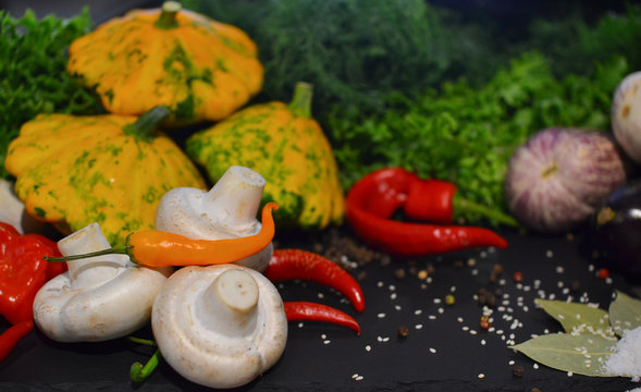 Beautiful fresh vegetables and mushrooms on a dark background