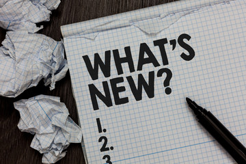 Text sign showing What s is New question. Conceptual photo Asking about latest Updates Trends Happening News Marker over notebook crumpled papers ripped pages several tries mistakes