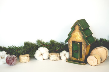 the concept of Christmas. branch ate , wooden cuts , cotton, house.