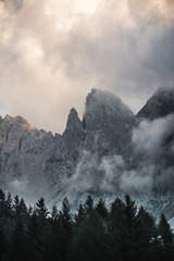 Beautiful dark rocky mountain peaks view during  a cloudy day in the italian Alps. Obscure and magic landscape concept