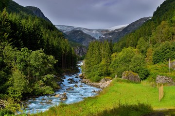 Norway landscape with blue river and the glacier.