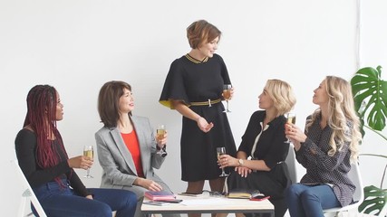 Females coworkers celebrating successful start-up of a new project.