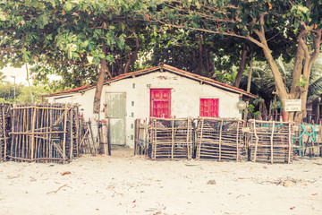 Fish cages/traps in front of a fisherman's house at the beach on Itamaraca island, Brazil