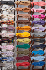 Stand with many fabric espadrilles of different colors