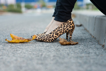 Woman sitting with leopard shoes