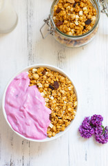 Bowl of Homemade granola with Blueberry Greek yogurt on a light background. Ingredients for a healthy breakfast. Top view
