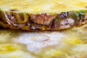 Ripe pineapple and pineapple slices on a wooden background tropical fruits