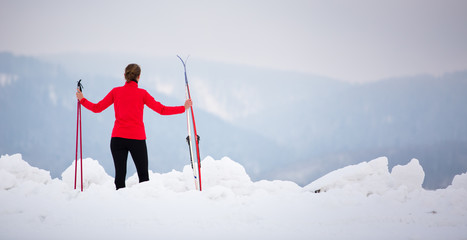 Cross-country skiing: young woman cross-country skiing on a  winter day (motion blurred image)